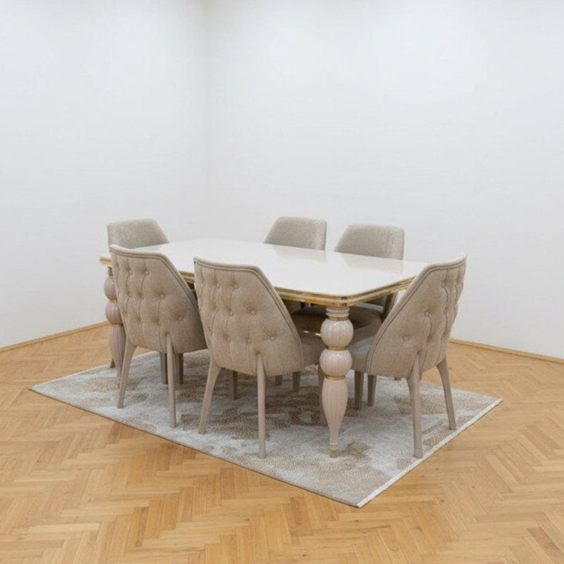 Dining room with a table and chairs on a wooden floor.